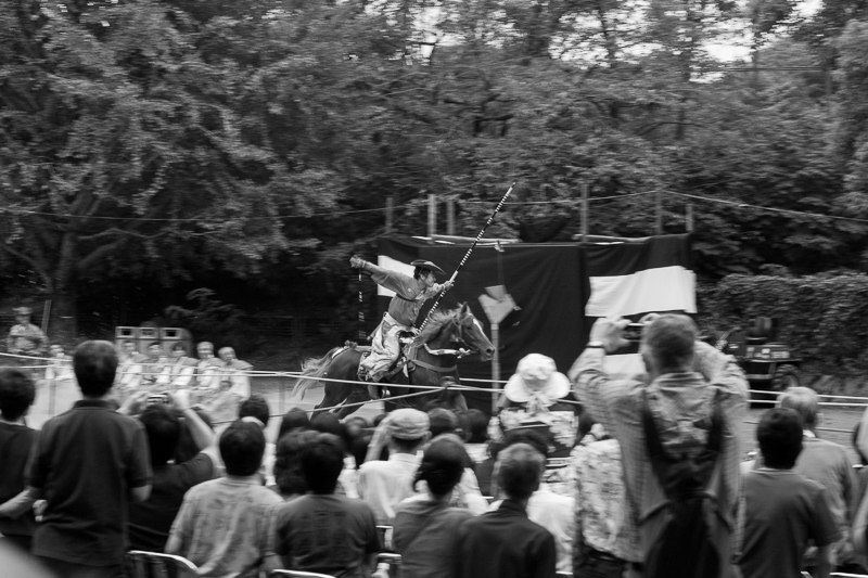The crowd cheers as the yabusame (流鏑馬) archer hits his target.